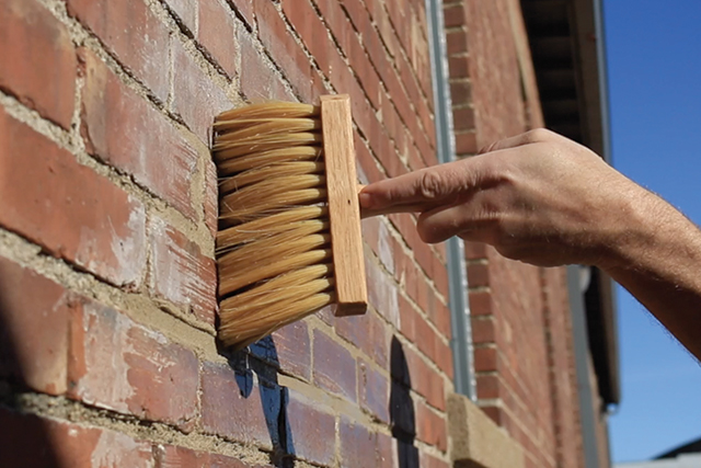 wet brush running over brick